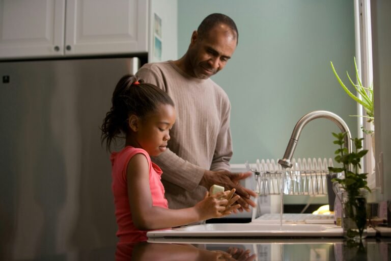 father and daughter holding a jug.